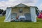 BLue and white vintage tent in a field.  Camping festival