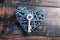 Blue wicker heart and a key on shabby wooden background