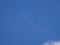 Blue wind kite in a blue sky with white clouds