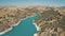 Blue winding river, yellow hills. Azure water, green bushes. Hydropower eco. Cyprus. Aerial view