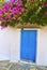 Blue window and bougainvillea at Cyclades Greece