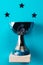 Blue winner cup on light blue background