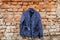 blue womens jacket weighs on hangers on the wall at home outdoors, womens jacket