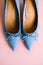 Blue womens shoes with heels on pink background