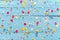 Blue wood background with scattered party confetti