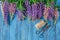 Blue wooden background with pink white lupines border and empty