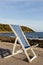 Blue wooden deckchair by the sea