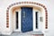 Blue wooden door, decorative tiles, windows and beige walls of the entrance of a vintage building