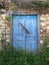 Blue Wooden Doors on Old Stone Greek Village House