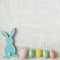 Blue wooden flat easter bunny lies on a white background. Copy space