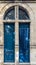 Blue wooden front two doors of street restored house entrance facade classic gate