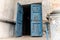 Blue wooden shabby door of porch in old apartment house