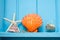 Blue wooden wall decoration with orange shellfish