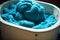 blue wool fibers in tub for painting weaving factory textile industry