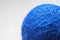 Blue wool yarn skein on cardboard background