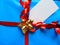 Blue wrapped gift with blank tag and pretty shiny ribbon