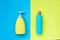 Blue and yellow bottles on yellow-blue background. empty space under the text. clean plastic packaging