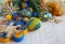 Blue and yellow eggs, felt garland and straw snowflakes on a light wooden background