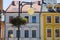 Blue and yellow houses facade with lamp and flower pot, summer