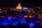 Blue and yellow illuminated cathedral and houses