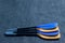 Blue and yellow paddle blades on the gray textured background. Look from the side