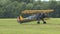 Blue and yellow plane taxiing on field