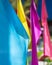 Blue, yellow, purple and pink flags on a sunny day