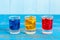 Blue, yellow, rad berry drink or liqueur with ice