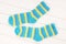 Blue and yellow socks are on white wooden background, isolated striped  terry multicoloured socks