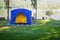 Blue and yellow tents on the lawn.