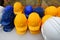 Blue, yellow and white helmets on construction site