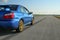 The blue youngtimer sports car on the concrete runway
