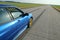 The blue youngtimer sports car on the concrete runway