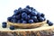 Blueberries in bamboo basket on white background