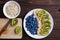 Blueberries, banana and kiwi slices on a plate and bowl with oat