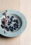 Blueberries in blue dish with flowers