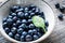 Blueberries in bowl on wooden background