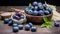 Blueberries in a bowl on a wooden background. Selective focus