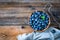 Blueberries in bowl on wooden table