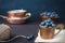 Blueberries dark picture. Fresh fruits, berries in an old copper cup. Dark Styled Stock Photo, Black Background