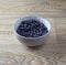 Blueberries in a grey bowl on a wooden table