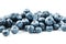 Blueberries isolated on a white background. A scattering of ripe, juicy, delicious and healthy berries
