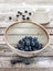 Blueberries in a metal strainer on vintage wood table