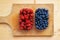 Blueberries and raspberries in plastic container boxes