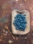 Blueberries in a rustic wooden serving dish over