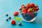 Blueberries and strawberry in Glass bowl on wooden table background