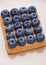 Blueberries on top of sweet waffle on plate closeup