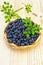 Blueberries in a wicker tray on a blackboard