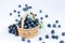 Blueberries wild berry in a wooden bowl a slide, raw fortified food, on a light background