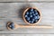 Blueberries on a wooden bowl, spoon